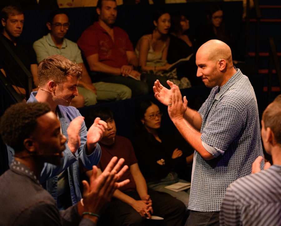 Performers applauding amid the audience at a Signature Theatre performance